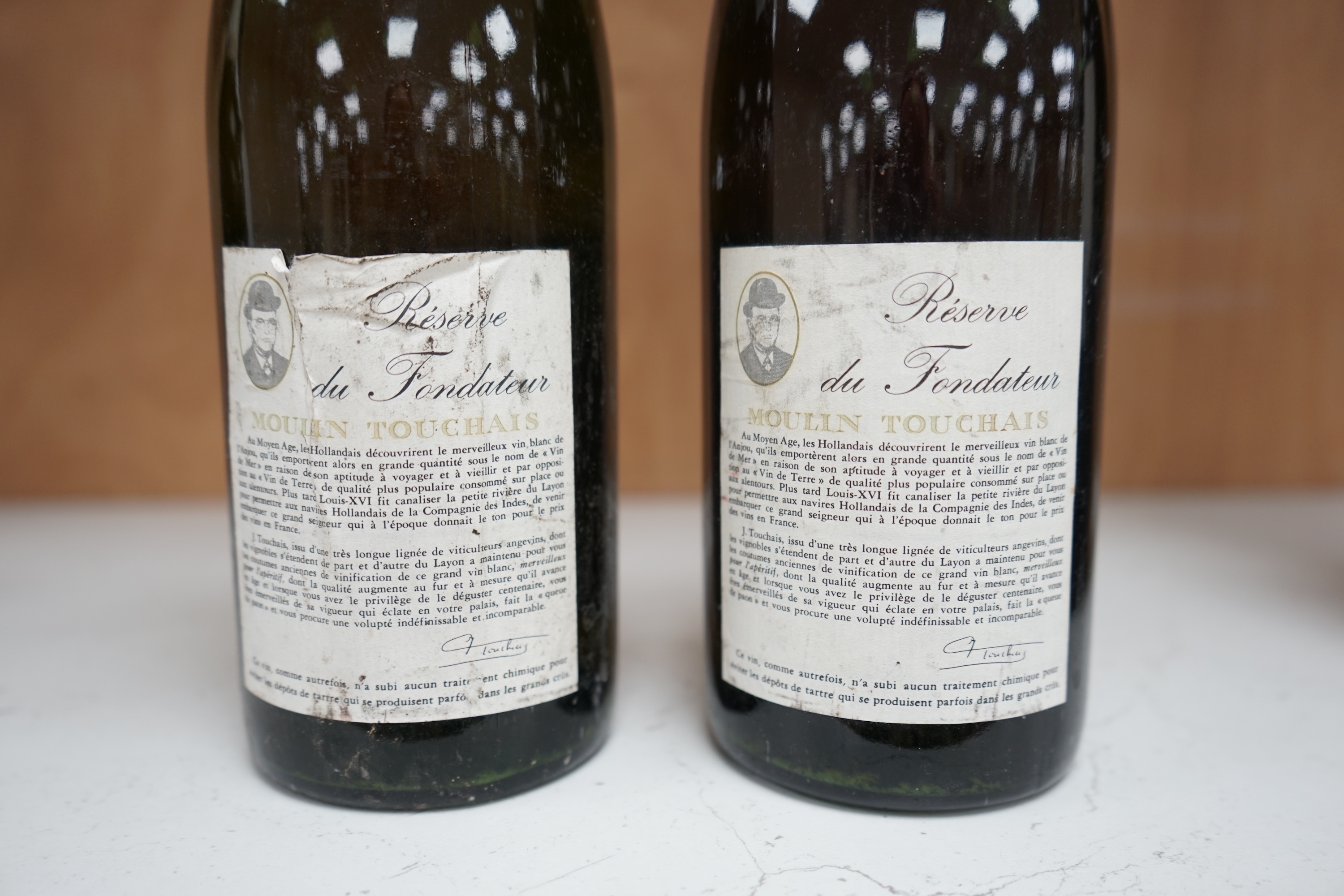 Two bottles of Moulin Touchais Anjou 1959 red wine. Condition - fair, staining to label, etc.